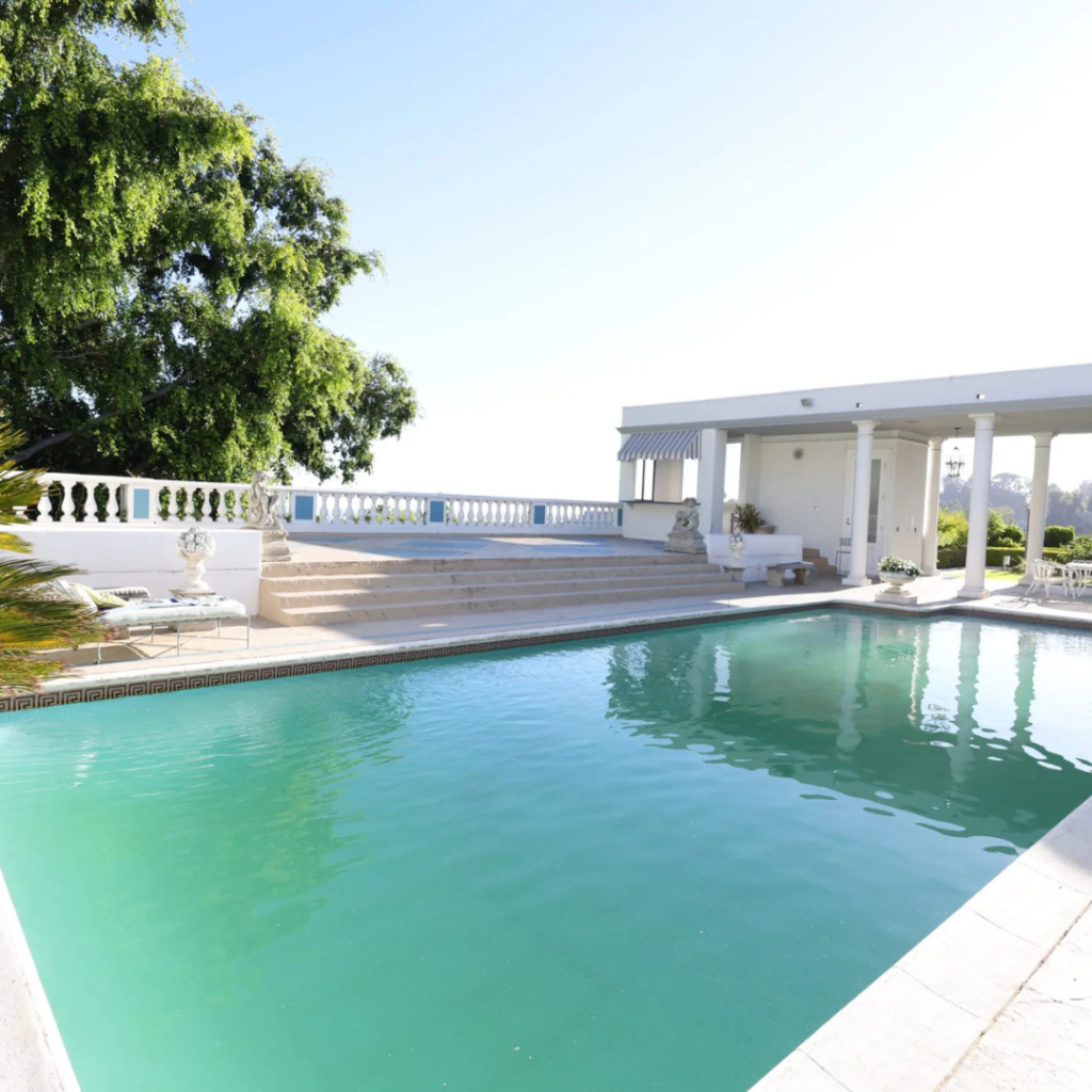 Stunning poolside terrace with Roman-inspired steps, ideal for ceremony setup or luxury dinners