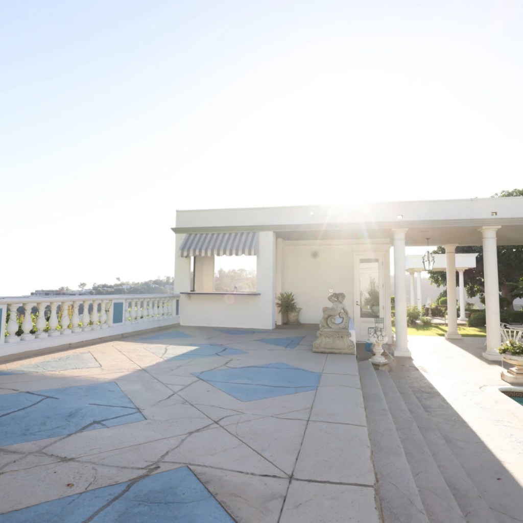 Sunlit terrace with lion statue and classic detailing, ready to be transformed into a personalized celebration space