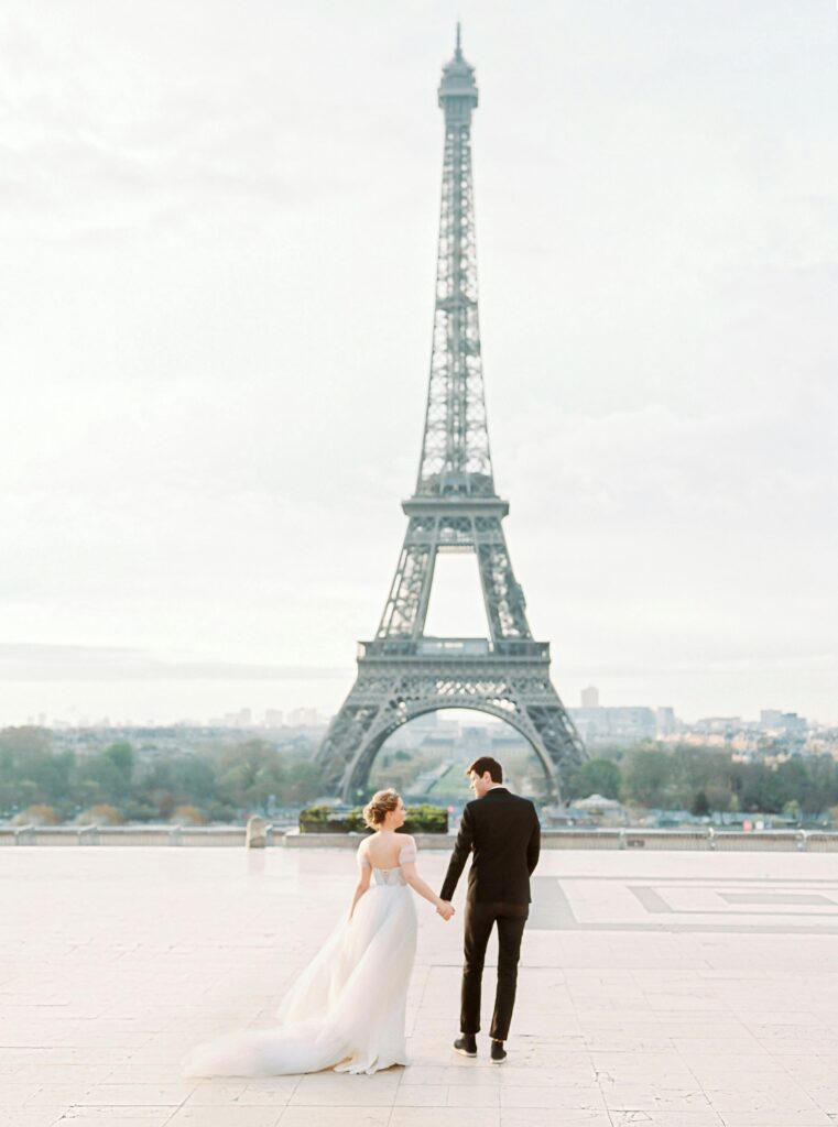 Bride and groom captured in front of the Eiffel Tower, styled with timeless elegance — a romantic destination wedding moment curated by Marshecka Weddings.