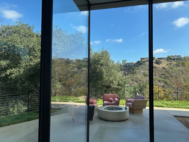 Elegant outdoor seating area framed by hillside views and California light.