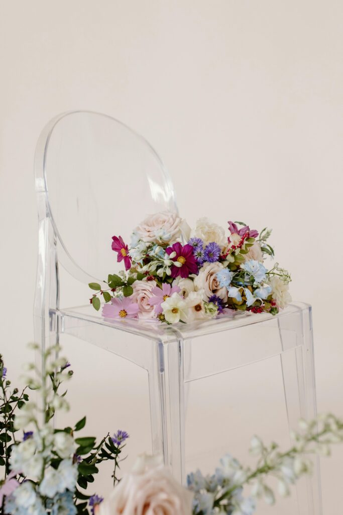 Elegant clear wedding chair with soft floral arrangement at a luxury tablescape, part of Marshecka Weddings ‘Mondays with Marshecka’ series.